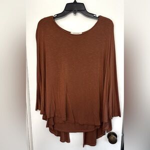 Long sleeve shirt with a cape like thing covering the front